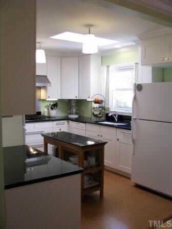 414 Tinkerbell Road Chapel Hill, NC 27517 - Photo 4 of 12 Updated chef's kitchen complete with 6 burner gas stove top, wall oven, and 900 CFM vent to the outdoors.