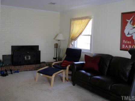 414 Tinkerbell Road Chapel Hill, NC 27517 - Photo 8 of 12 The lower level family room is complete with fireplace and built-in bookshelves. Great for movie viewing!
