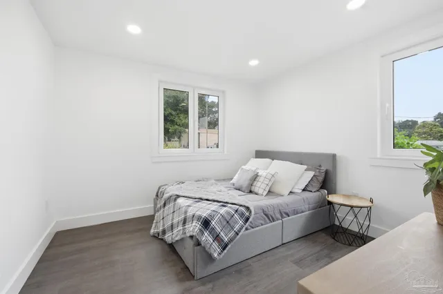 a kitchen with white cabinets sink and stainless steel appliances
