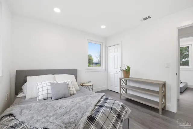 a bedroom with a bed and a window