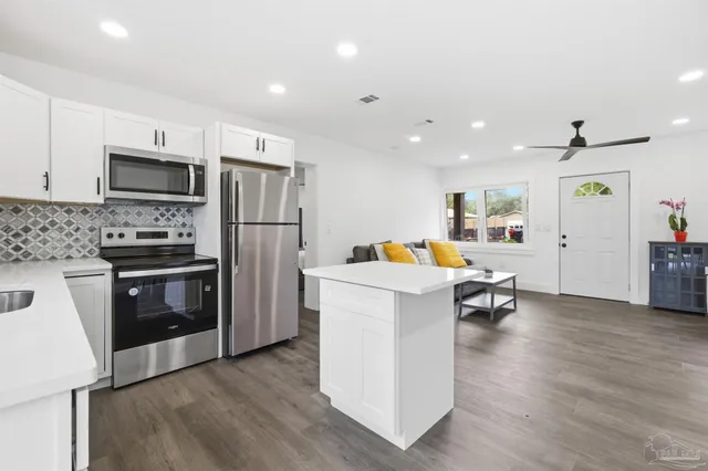 a kitchen with refrigerator and cabinets