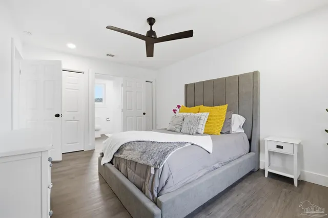 a bedroom with a bed and a ceiling fan