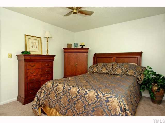 5827 Shady Grove Circle Raleigh, NC 27609 - Photo 6 of 11 Spacious master bedroom with ceiling fan, double his/her closets, deep linen closet right outside the bedroom for additional storage, great lighting through long double windows. Tree view from master. Attic storage as well.
