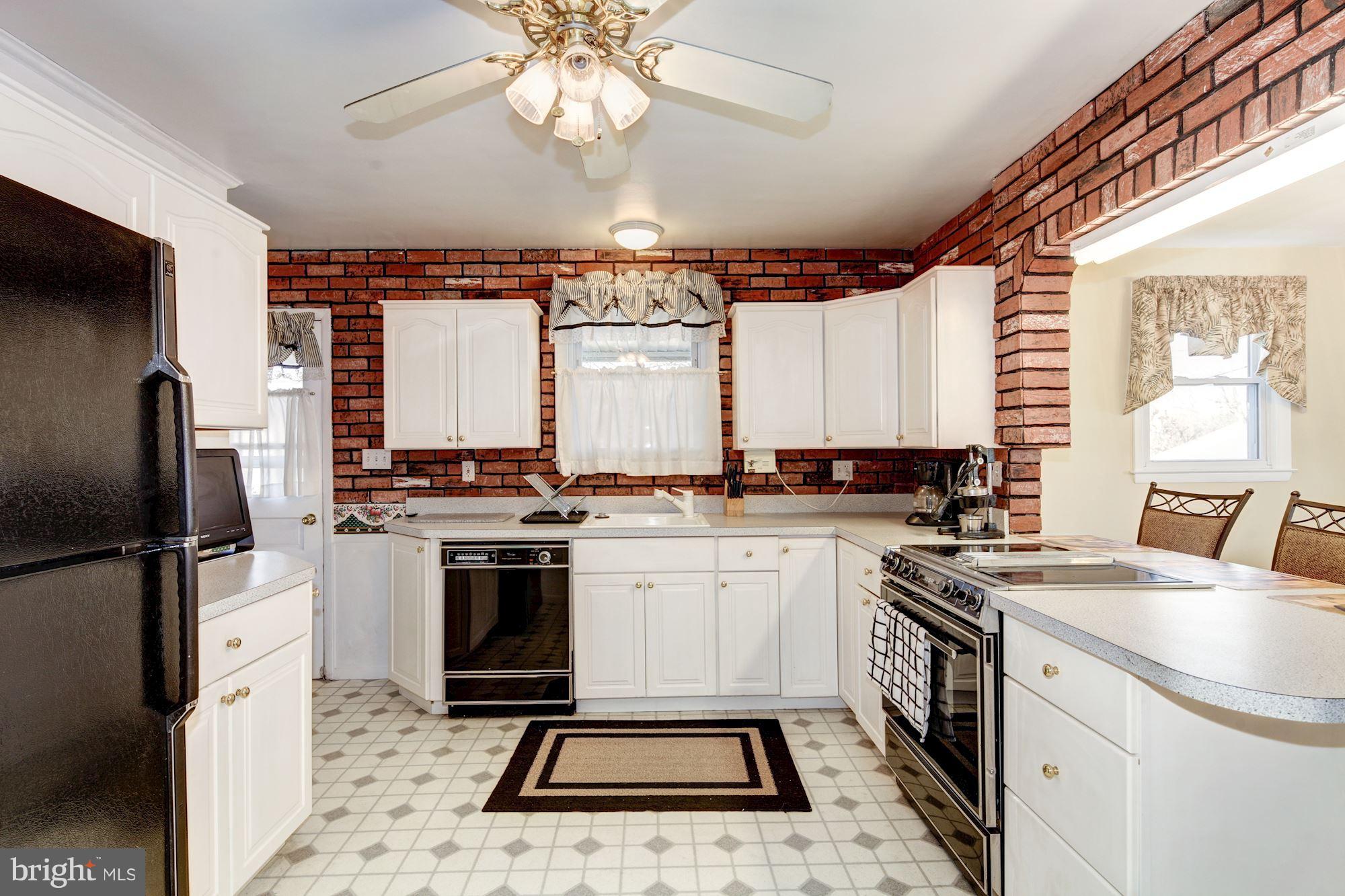 702 Edgewood Road Linthicum Heights, MD 21090 - Photo 8 of 21 a kitchen with a stove a sink and a refrigerator