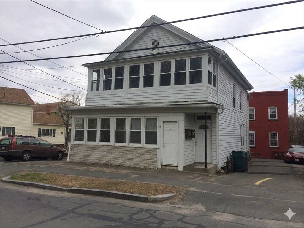 a view of a white house with a street