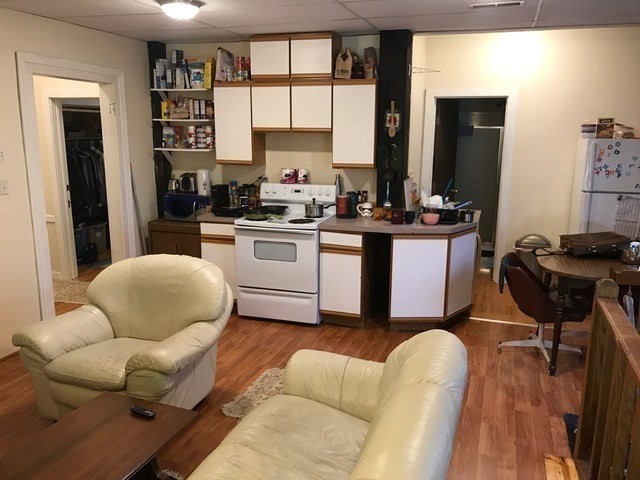 79 Hawley Street, Unit D Northampton, MA 01060 - Photo 2 of 6 a living room with furniture a large window and kitchen view