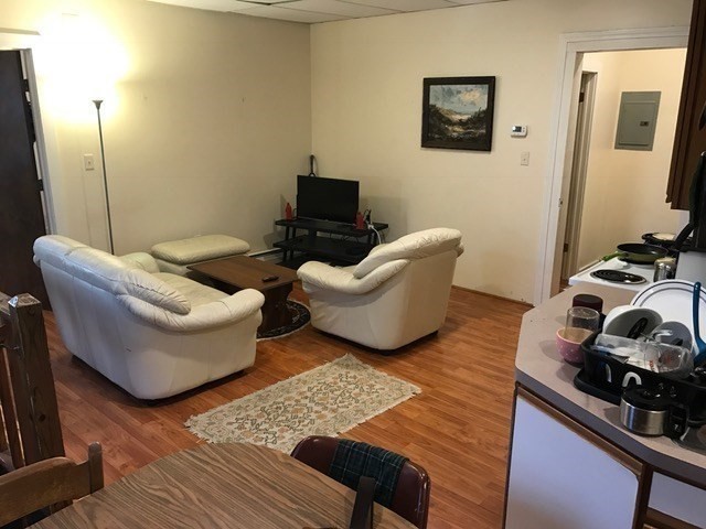 79 Hawley Street, Unit D Northampton, MA 01060 - Photo 3 of 6 a living room with furniture and a flat screen tv