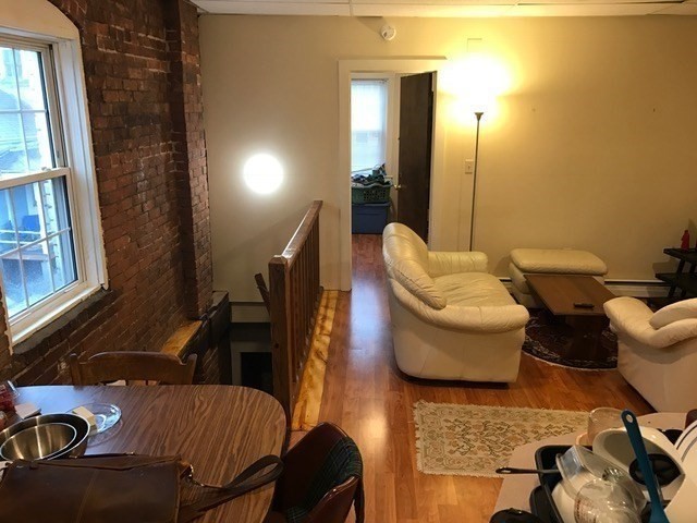 79 Hawley Street, Unit D Northampton, MA 01060 - Photo 4 of 6 a living room with furniture and a window