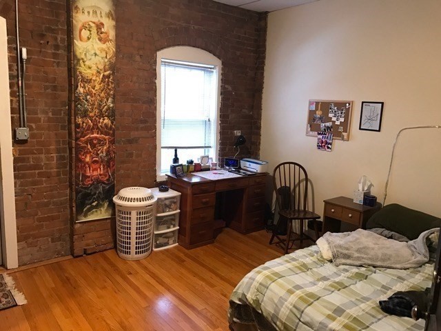 79 Hawley Street, Unit D Northampton, MA 01060 - Photo 5 of 6 a bedroom with a bed and dresser