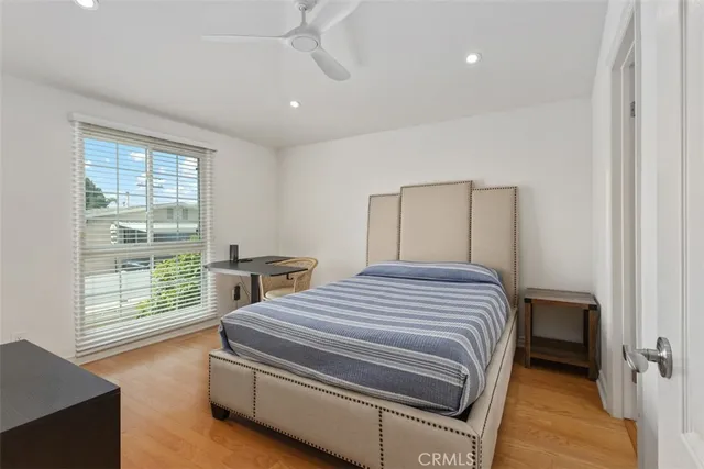 a bedroom with a bed and a large window