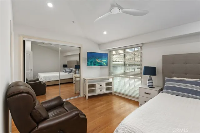 a bedroom with furniture and a flat screen tv