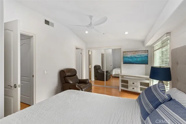 a bedroom with furniture and a flat screen tv