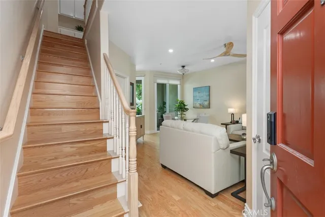 a view of entryway and hall with wooden floor