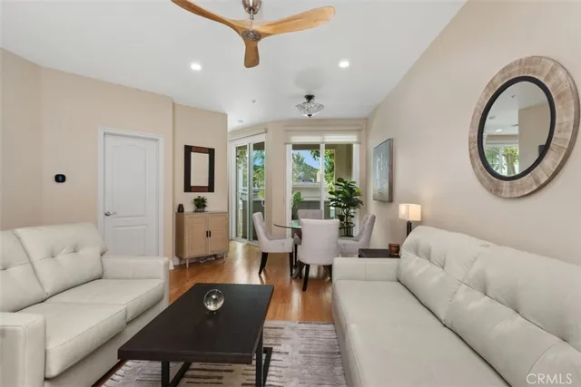 a living room with furniture a table and a potted plant