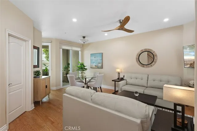 a living room with furniture a lamp and a chandelier