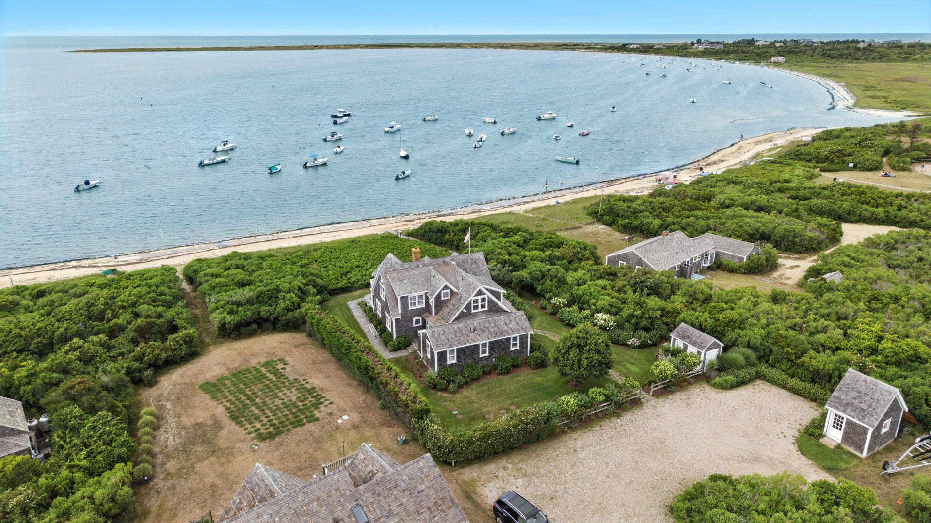 1 Little Neck Way, Unit 1 Nantucket, MA 02554 - Photo 2 of 99 an aerial view of a house with a yard and lake view