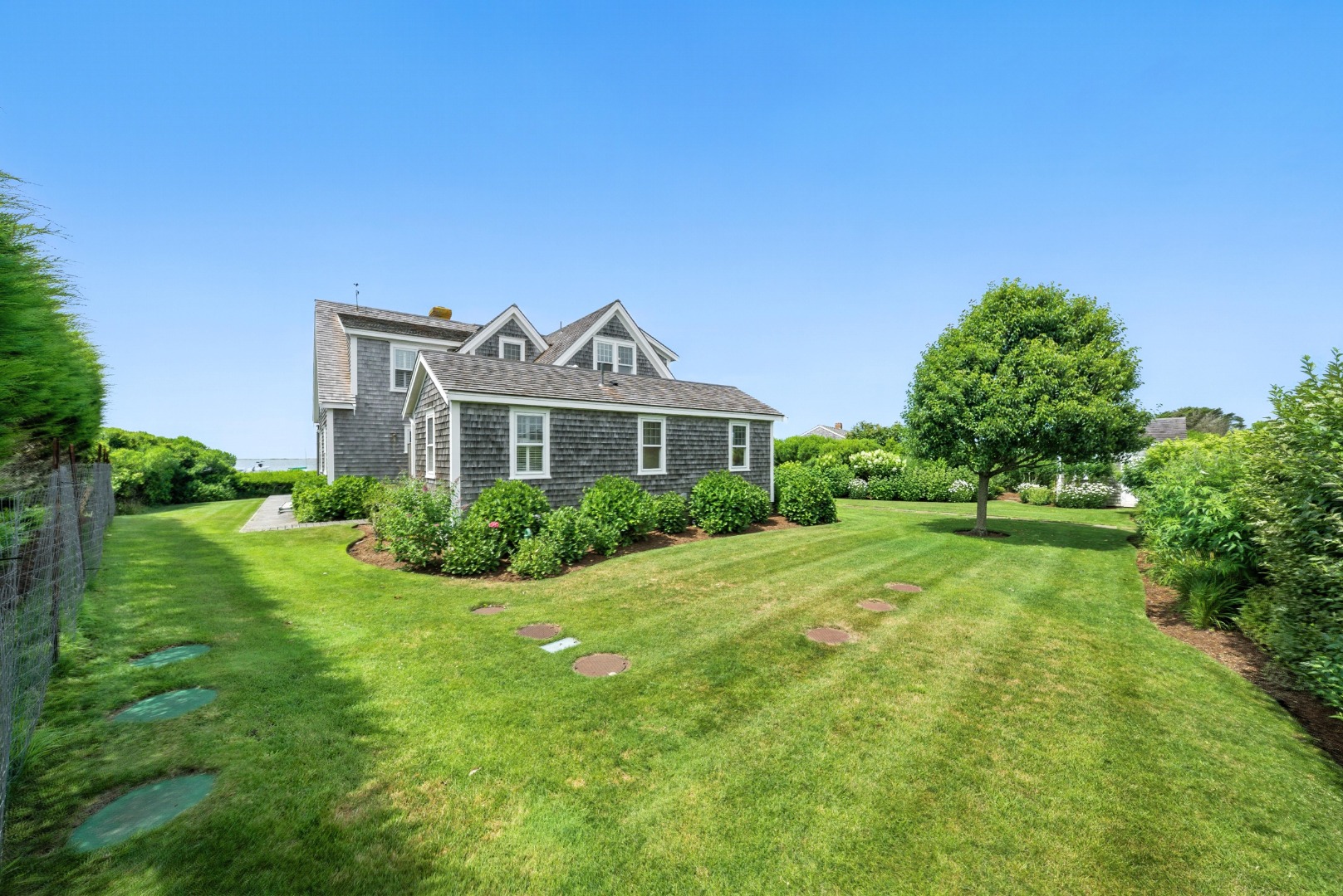 1 Little Neck Way, Unit 1 Nantucket, MA 02554 - Photo 22 of 99 a front view of a house with a yard