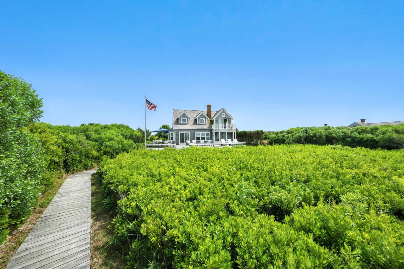 1 Little Neck Way, Unit 1 Nantucket, MA 02554 - Photo 25 of 99 a view of a garden with a building in the background
