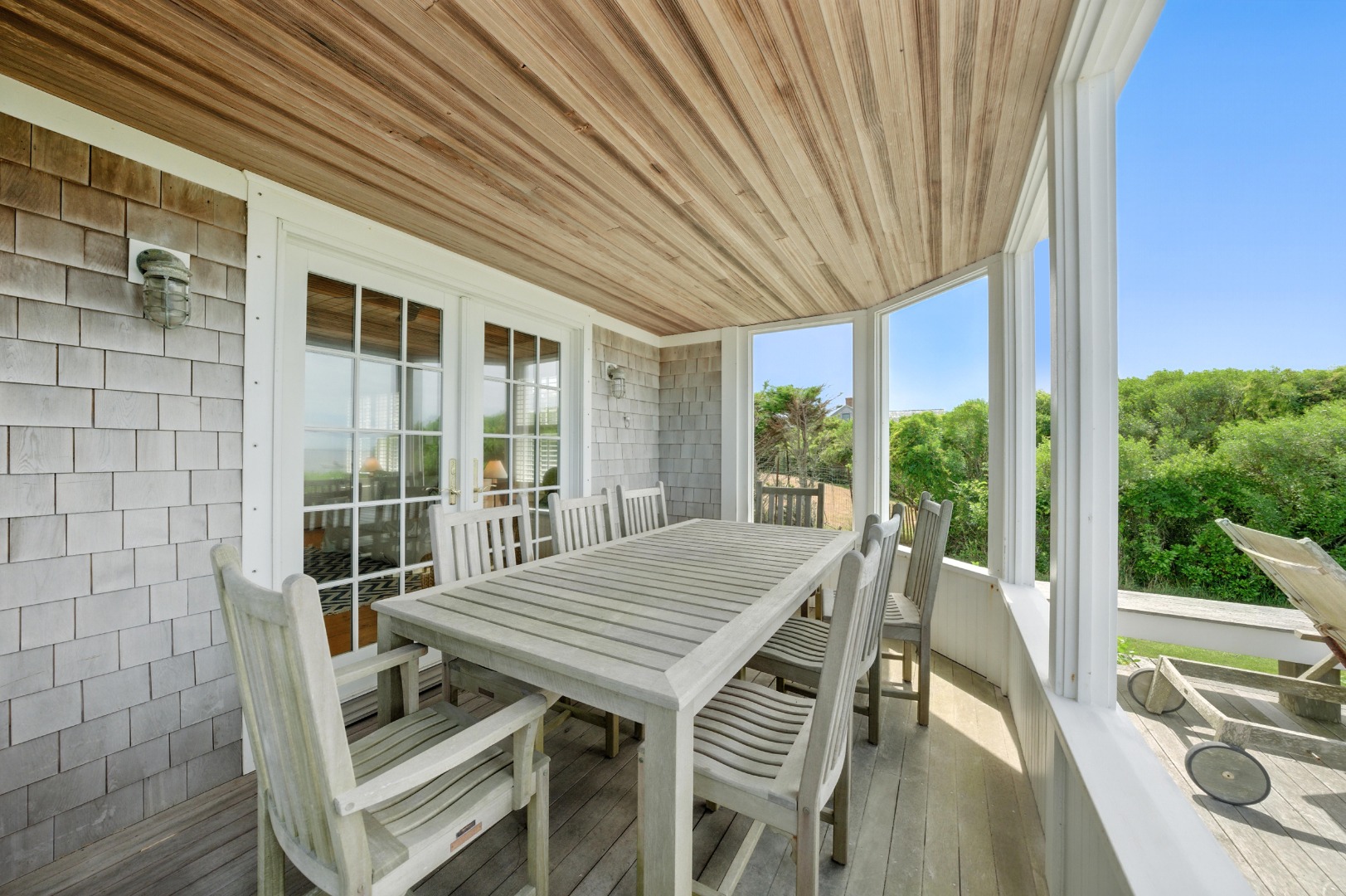 1 Little Neck Way, Unit 1 Nantucket, MA 02554 - Photo 82 of 99 a view of a patio with table and chairs in front of a house