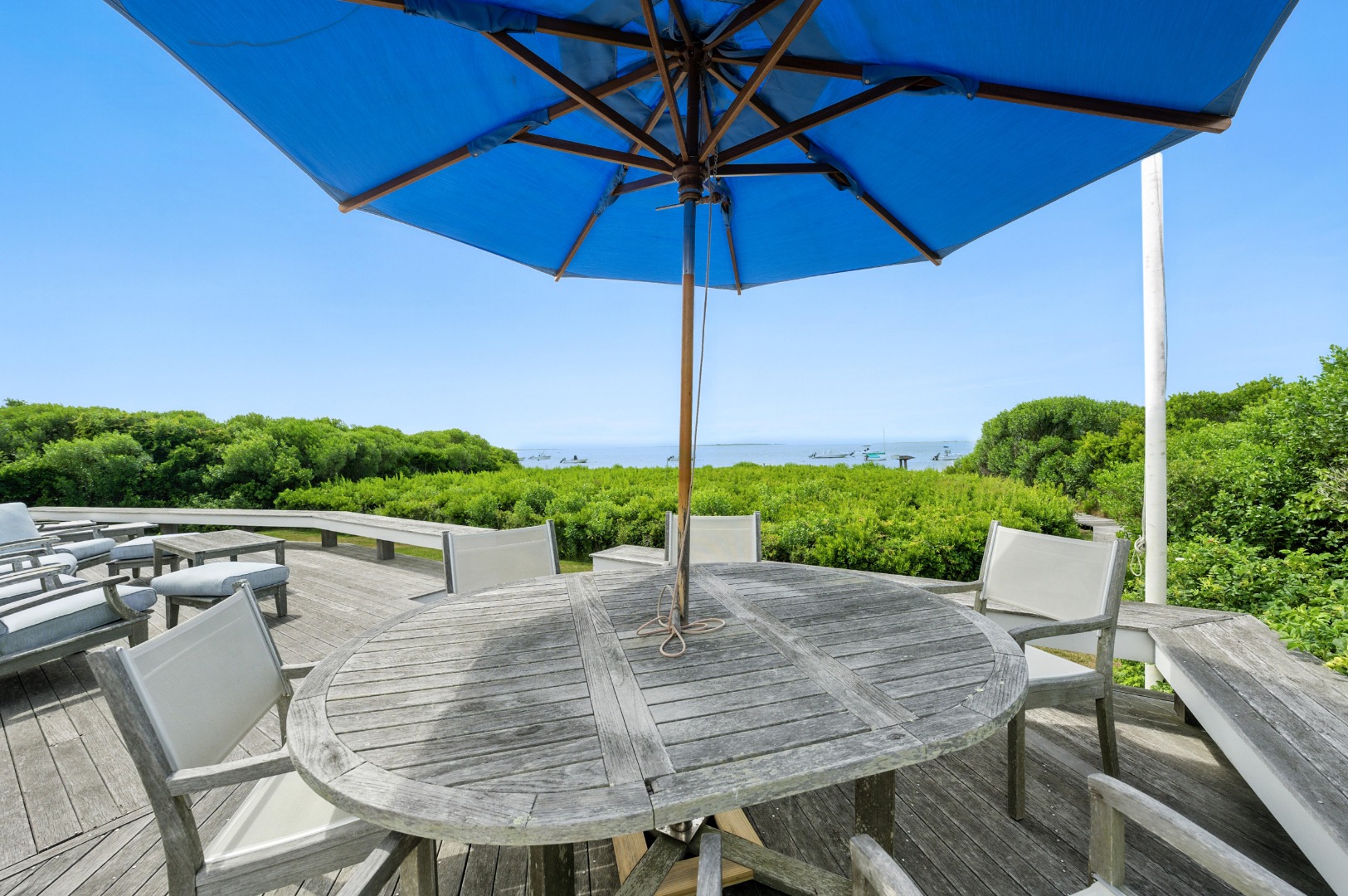 1 Little Neck Way, Unit 1 Nantucket, MA 02554 - Photo 92 of 99 a view of a patio with a table chairs and a umbrella