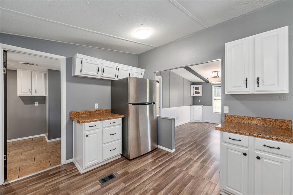 5600 Southeast 39th Street Trenton, FL 32693 - Photo 15 of 73 a kitchen with stainless steel appliances granite countertop a refrigerator and a stove top oven