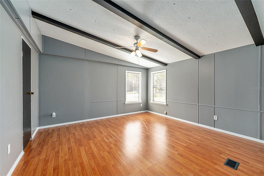 5600 Southeast 39th Street Trenton, FL 32693 - Photo 19 of 73 a view of an empty room with window and wooden floor