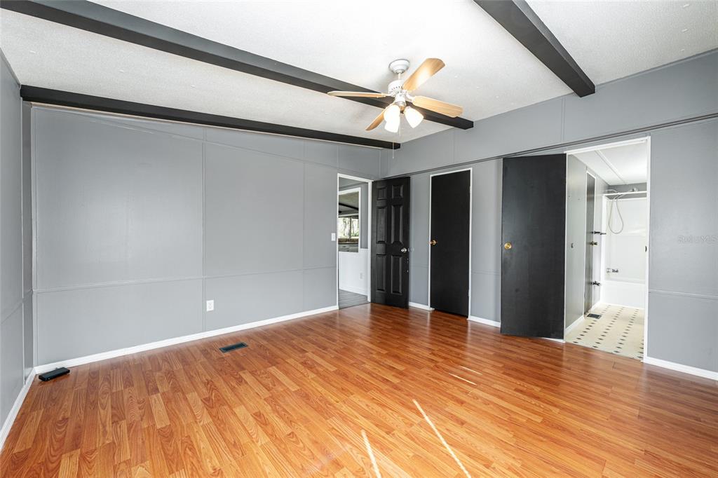 5600 Southeast 39th Street Trenton, FL 32693 - Photo 20 of 73 a view of an empty room with wooden floor and a window