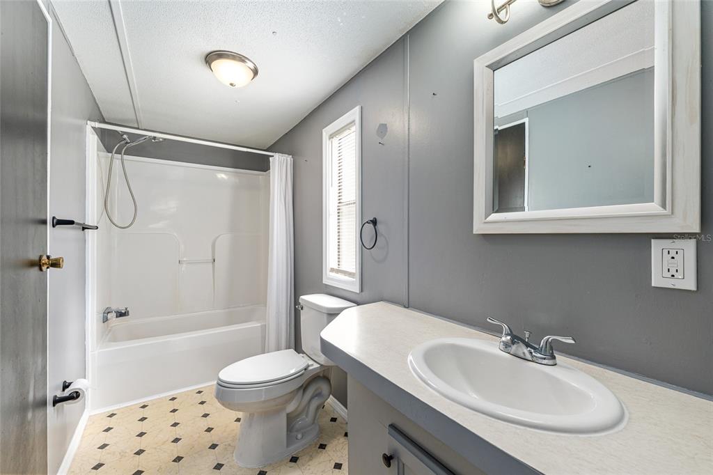 5600 Southeast 39th Street Trenton, FL 32693 - Photo 21 of 73 a bathroom with a sink toilet and shower