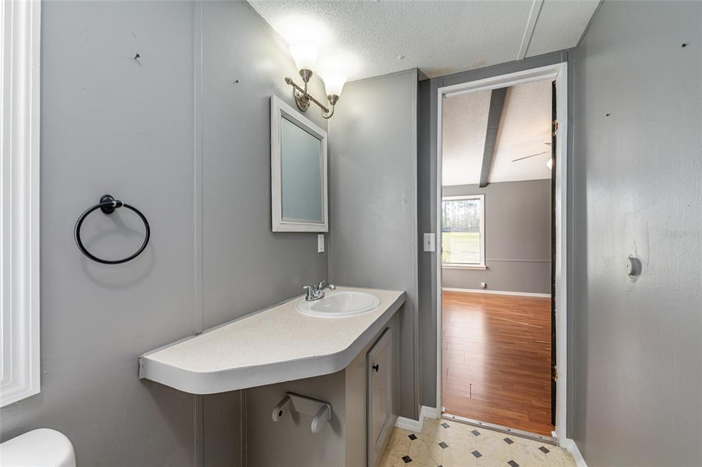 5600 Southeast 39th Street Trenton, FL 32693 - Photo 23 of 73 a bathroom with a sink a toilet and shower