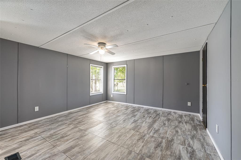 5600 Southeast 39th Street Trenton, FL 32693 - Photo 26 of 73 a view of an empty room with window and wooden floor