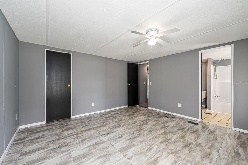 5600 Southeast 39th Street Trenton, FL 32693 - Photo 27 of 73 a view of empty room with wooden floor and fan