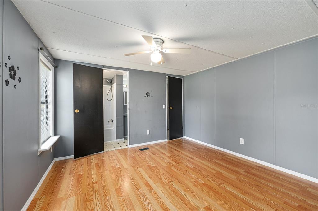 5600 Southeast 39th Street Trenton, FL 32693 - Photo 32 of 73 a bedroom with a bed and a chandelier