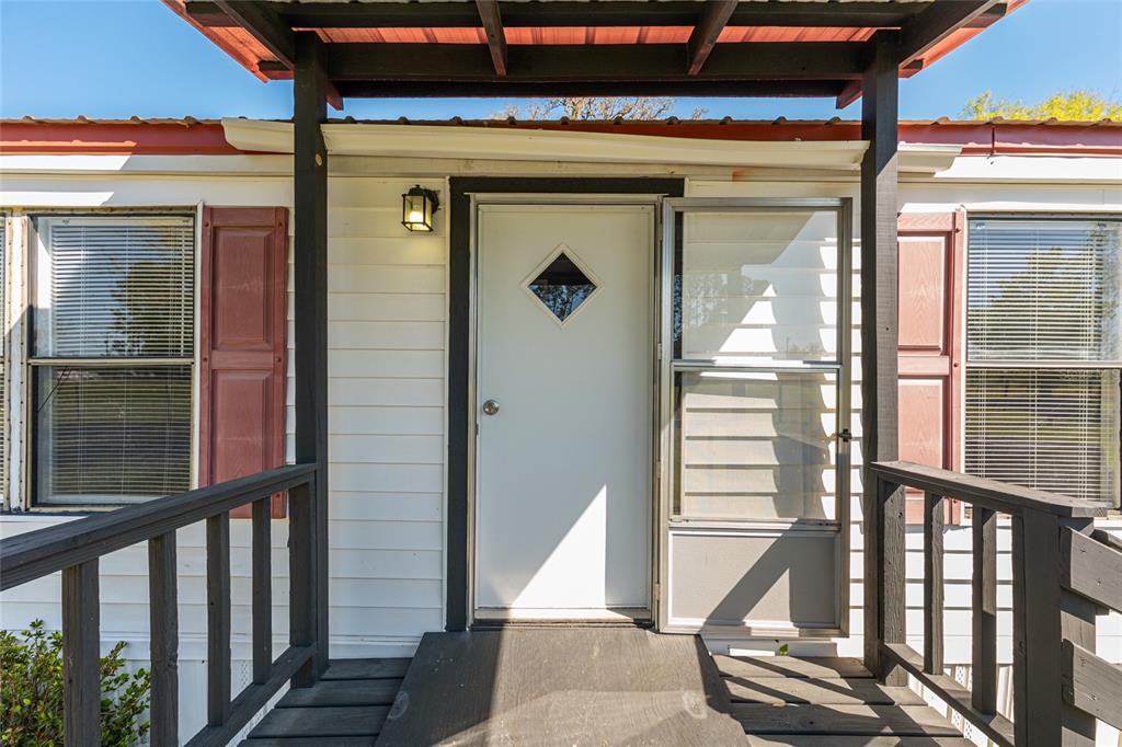 5600 Southeast 39th Street Trenton, FL 32693 - Photo 44 of 73 a front view of a house with a glass door