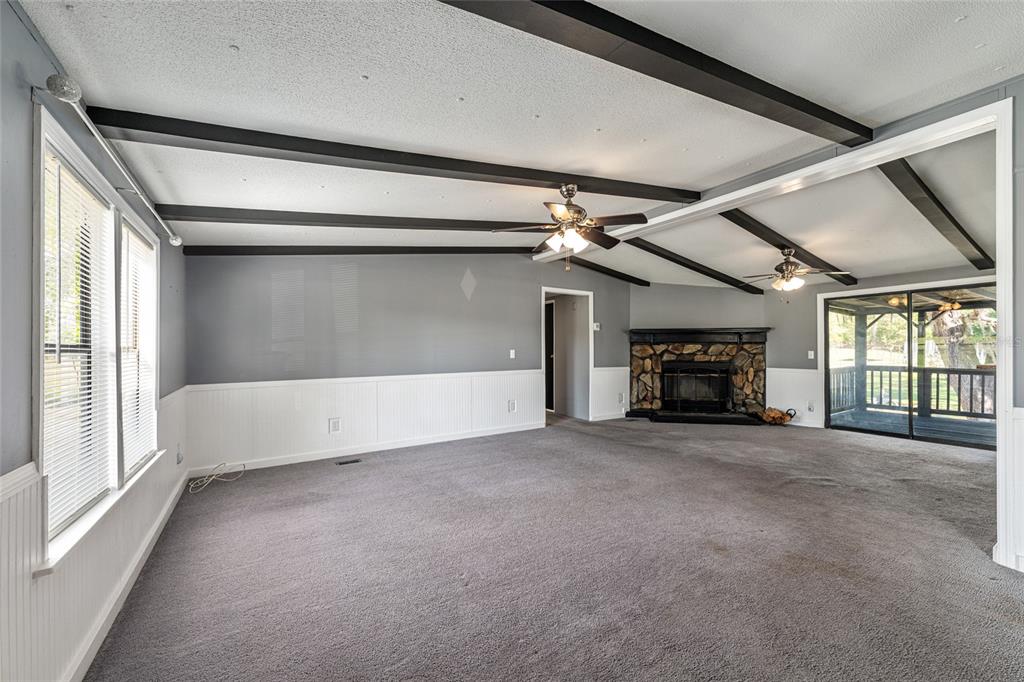5600 Southeast 39th Street Trenton, FL 32693 - Photo 5 of 73 a view of an empty room with a fireplace and a window