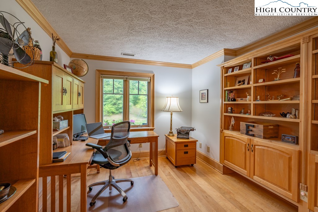 6985 Junaluska Road Boone, NC 28607 - Photo 20 of 49 a view of a workspace with furniture and a window