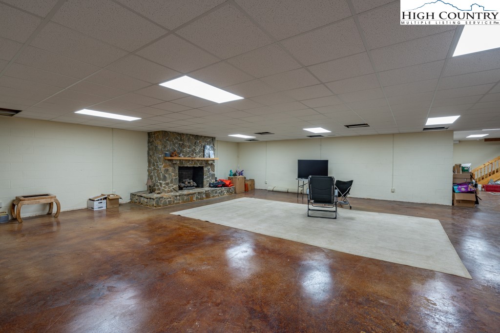 6985 Junaluska Road Boone, NC 28607 - Photo 33 of 49 a room with lots of furniture and a wooden floor