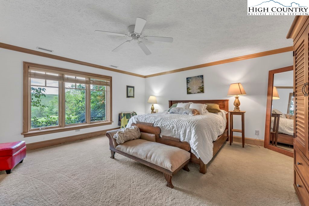 6985 Junaluska Road Boone, NC 28607 - Photo 38 of 49 a spacious bedroom with a large bed and a large window