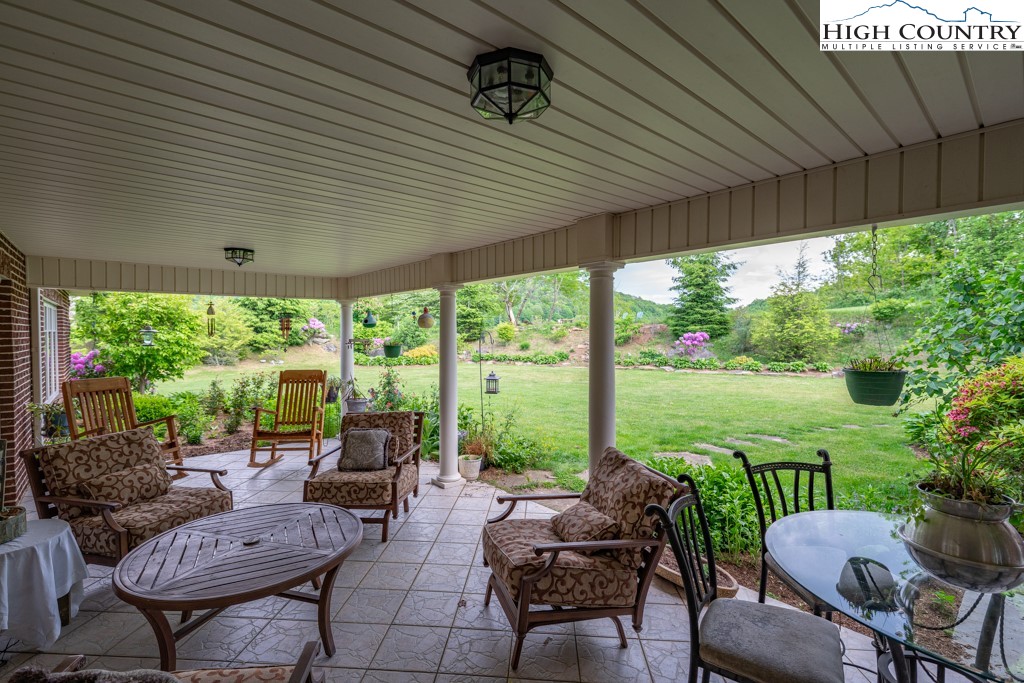 6985 Junaluska Road Boone, NC 28607 - Photo 4 of 49 a view of a patio with couches chairs and a table and chairs