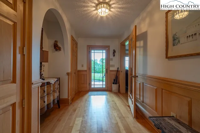 a kitchen with stainless steel appliances granite countertop a sink a stove and a wooden floors