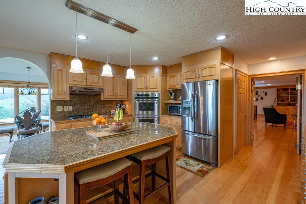 6985 Junaluska Road Boone, NC 28607 - Photo 8 of 49 a kitchen with stainless steel appliances granite countertop a refrigerator a sink and a stove