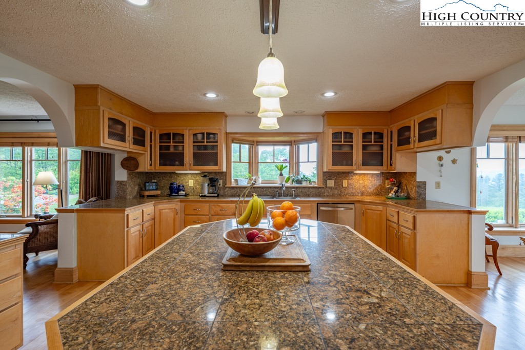 6985 Junaluska Road Boone, NC 28607 - Photo 9 of 49 a kitchen with stainless steel appliances granite countertop a stove and refrigerator