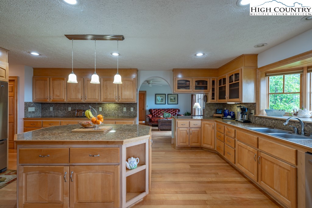 6985 Junaluska Road Boone, NC 28607 - Photo 10 of 49 a kitchen with stainless steel appliances granite countertop a sink a stove and a wooden floors
