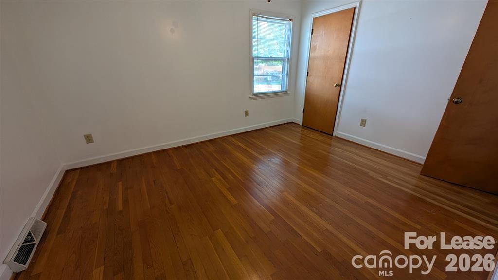 534 Westside Terrace Davidson, NC 28036 - Photo 13 of 18 an empty room with wooden floor