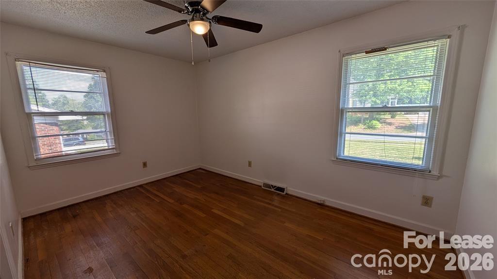 534 Westside Terrace Davidson, NC 28036 - Photo 15 of 18 a view of an empty room with a window and wooden floor