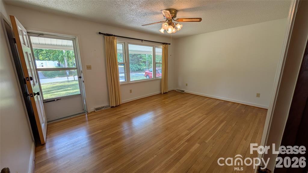 534 Westside Terrace Davidson, NC 28036 - Photo 5 of 18 an empty room with wooden floor and windows
