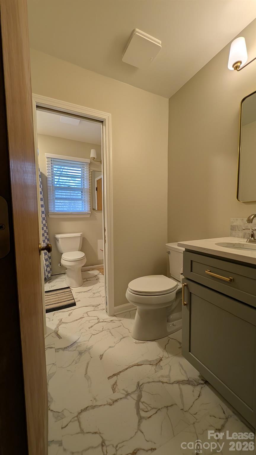 534 Westside Terrace Davidson, NC 28036 - Photo 10 of 18 a bathroom with a toilet a sink and shower