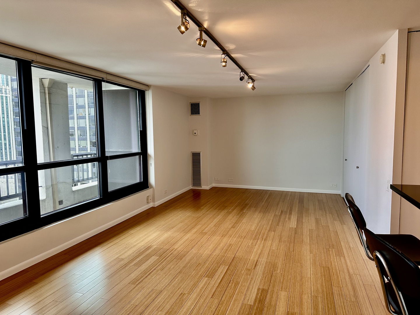 Undisclosed Address Chicago, IL 60610 - Photo 2 of 16 a view of an empty room with wooden floor and a window