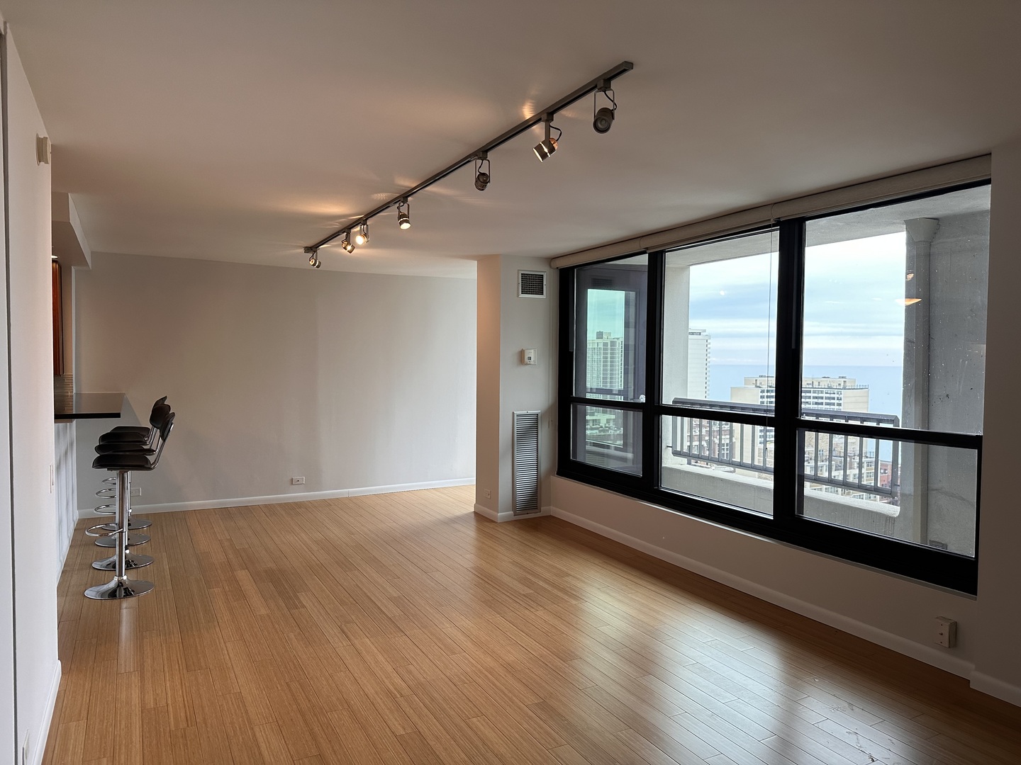 Undisclosed Address Chicago, IL 60610 - Photo 3 of 16 a view of a room with wooden floor and large windows