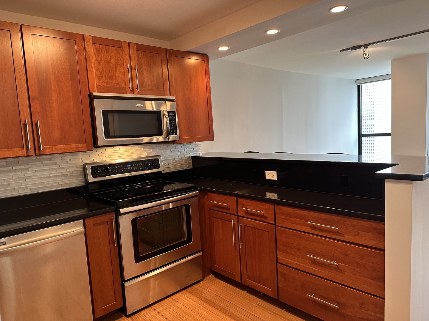 Undisclosed Address Chicago, IL 60610 - Photo 8 of 16 a kitchen with wooden cabinets and stainless steel appliances