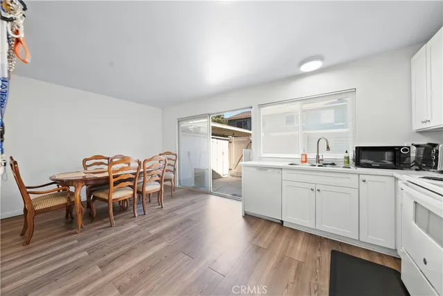 a kitchen with granite countertop furniture dining table and wooden floor